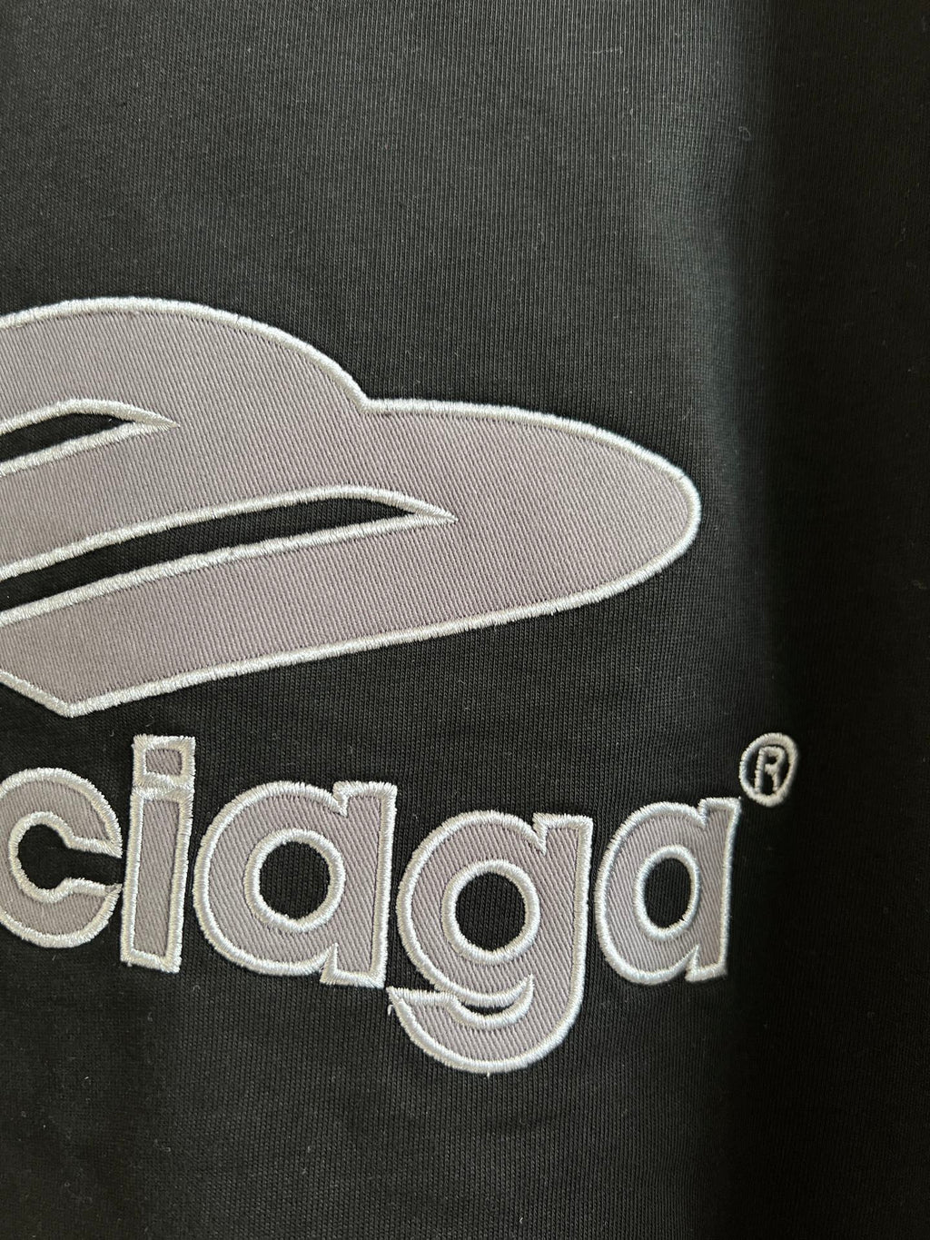 Close-up of black T-shirt chest logo with Balenciaga lettering embroidery