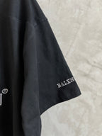 Black T-shirt side with small Balenciaga logo patch on sleeve