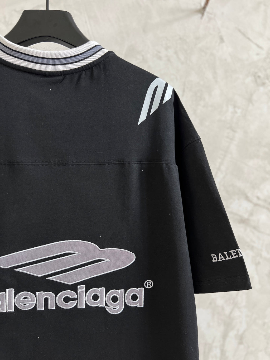 Black short-sleeve T-shirt sleeve detail with Balenciaga logo print