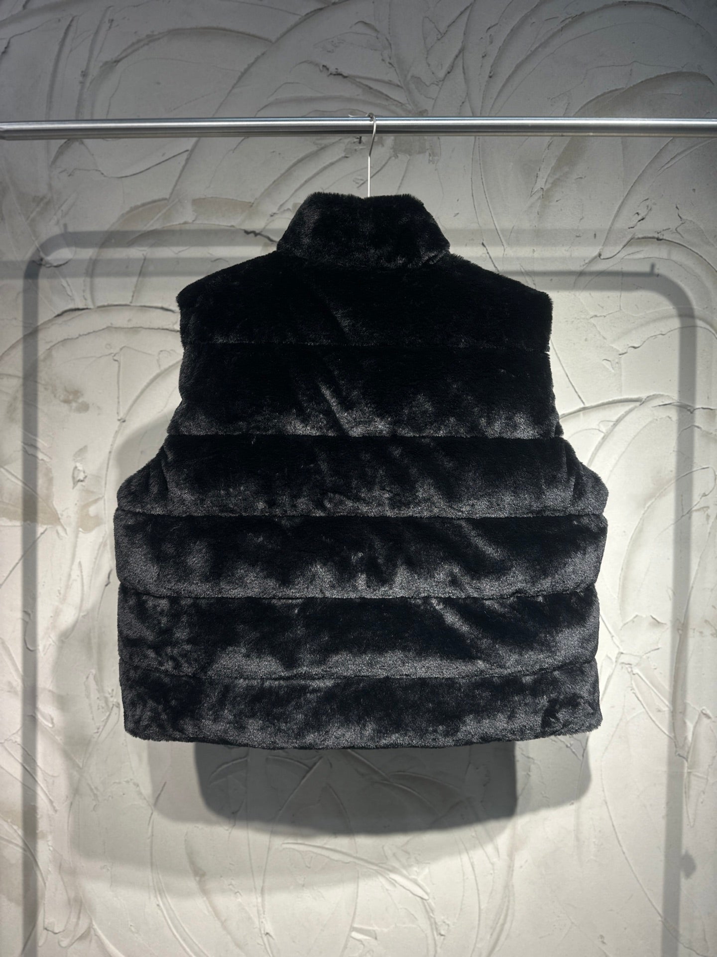 Black faux-fur puffer vest front view with stand collar.