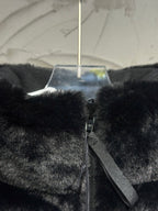 Black faux-fur puffer vest front detail with zipper tape and side strap.
