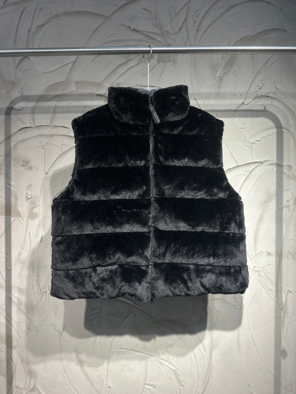 Black faux-fur puffer vest with stand collar and front zipper.