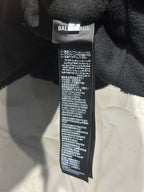 Black garment neck label reading BALENCIAGA with care instructions