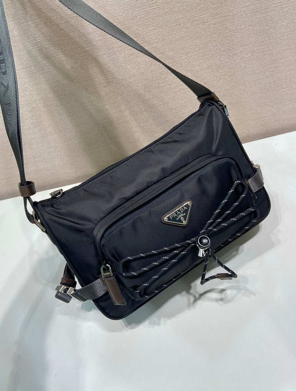 Prada nylon crossbody bag, dark blue, quilted panel, triangular logo, adjustable strap