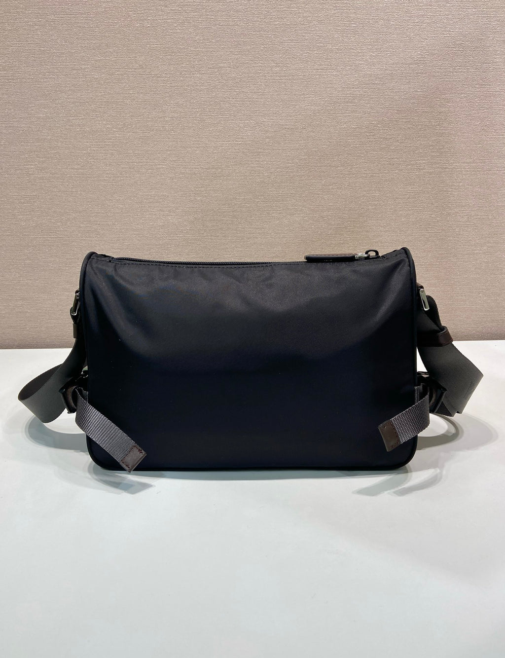 Prada nylon bag in dark blue with smooth back panel and two adjustable shoulder straps