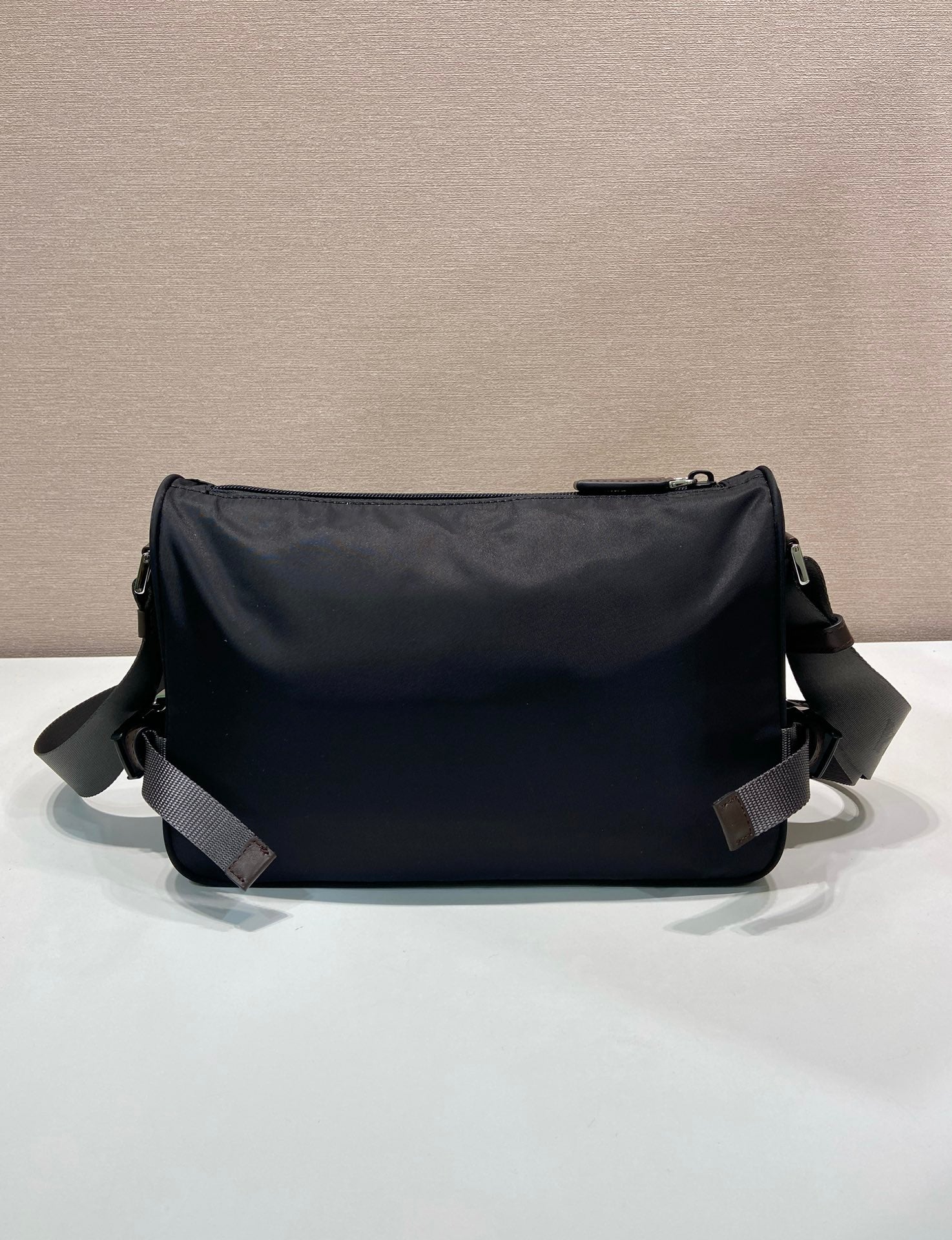 Prada nylon bag in dark blue with smooth back panel and two adjustable shoulder straps
