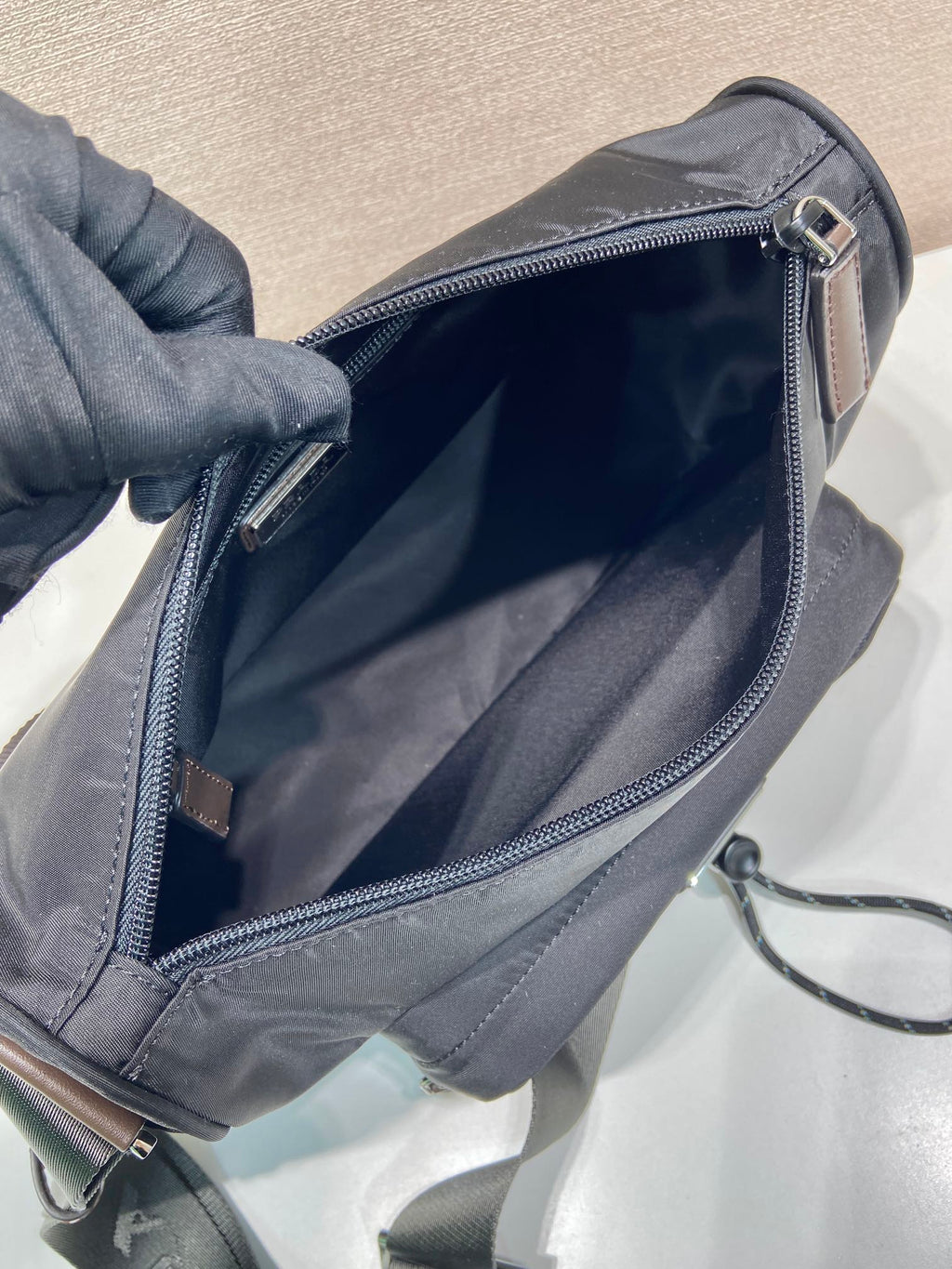 Prada nylon bag interior view with zipped opening and gray lining