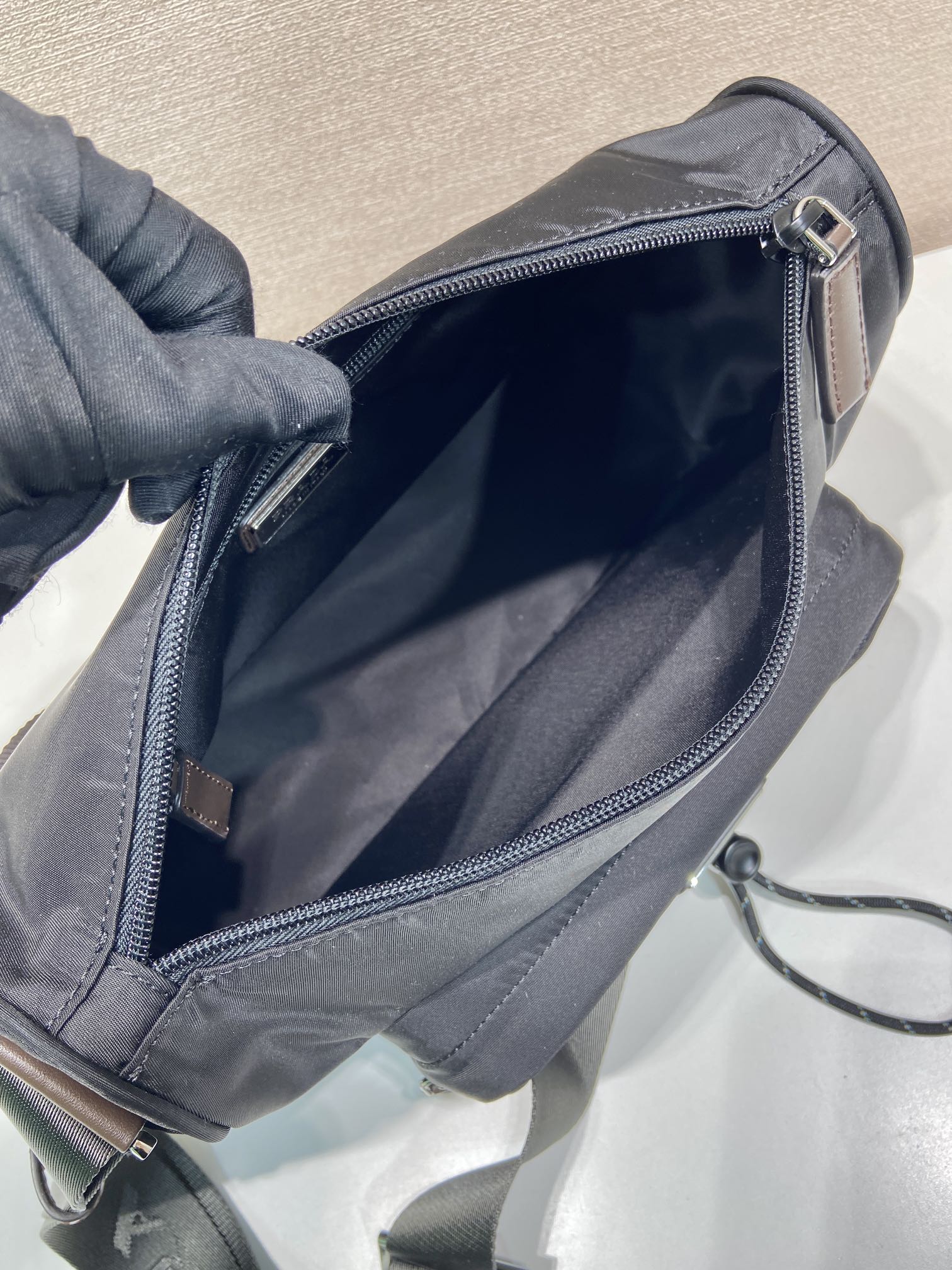Prada nylon bag interior view with zipped opening and gray lining