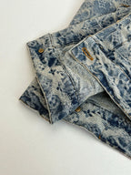 Close-up of blue denim pants waistband and front button with gold hardware
