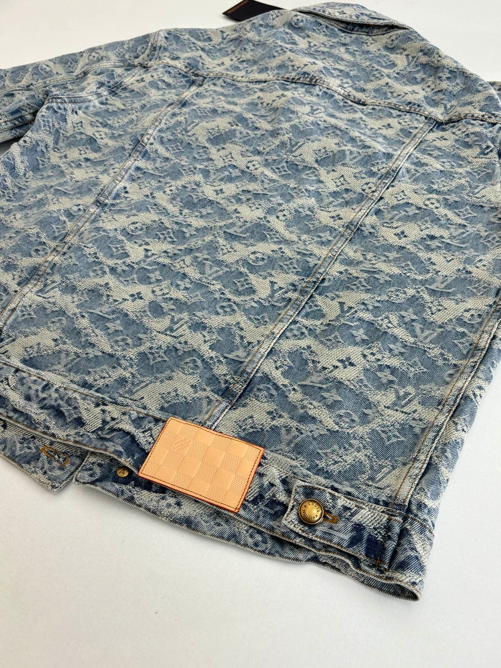 Long denim jacket with blue monogram print, front flap pocket and button details