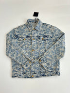 Blue denim jacket front view with allover monogram pattern, gold buttons, pointed collar