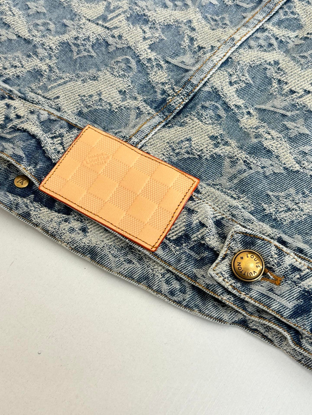 Blue denim jacket with monogram print, tan LV leather patch and gold button