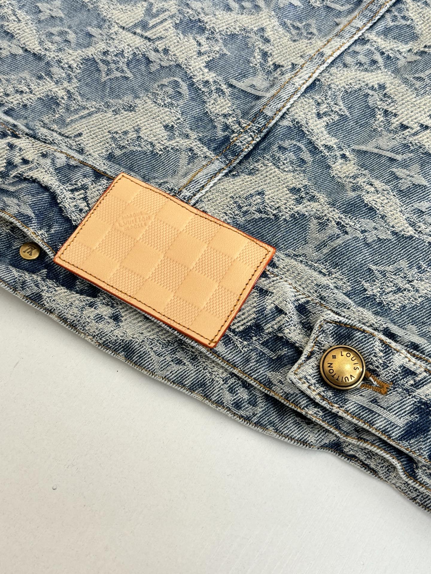 Blue denim jacket with monogram print, tan LV leather patch and gold button
