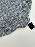 Blue monogram denim garment with diagonal seam stitching and Louis Vuitton tag