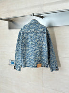 Back view of blue denim jacket with allover monogram pattern and button closure