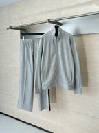 Grey Gucci zip-up jacket and matching pants set on hangers