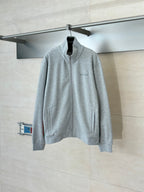 Grey Gucci zip-up jacket on hanger, standing collar, small chest logo