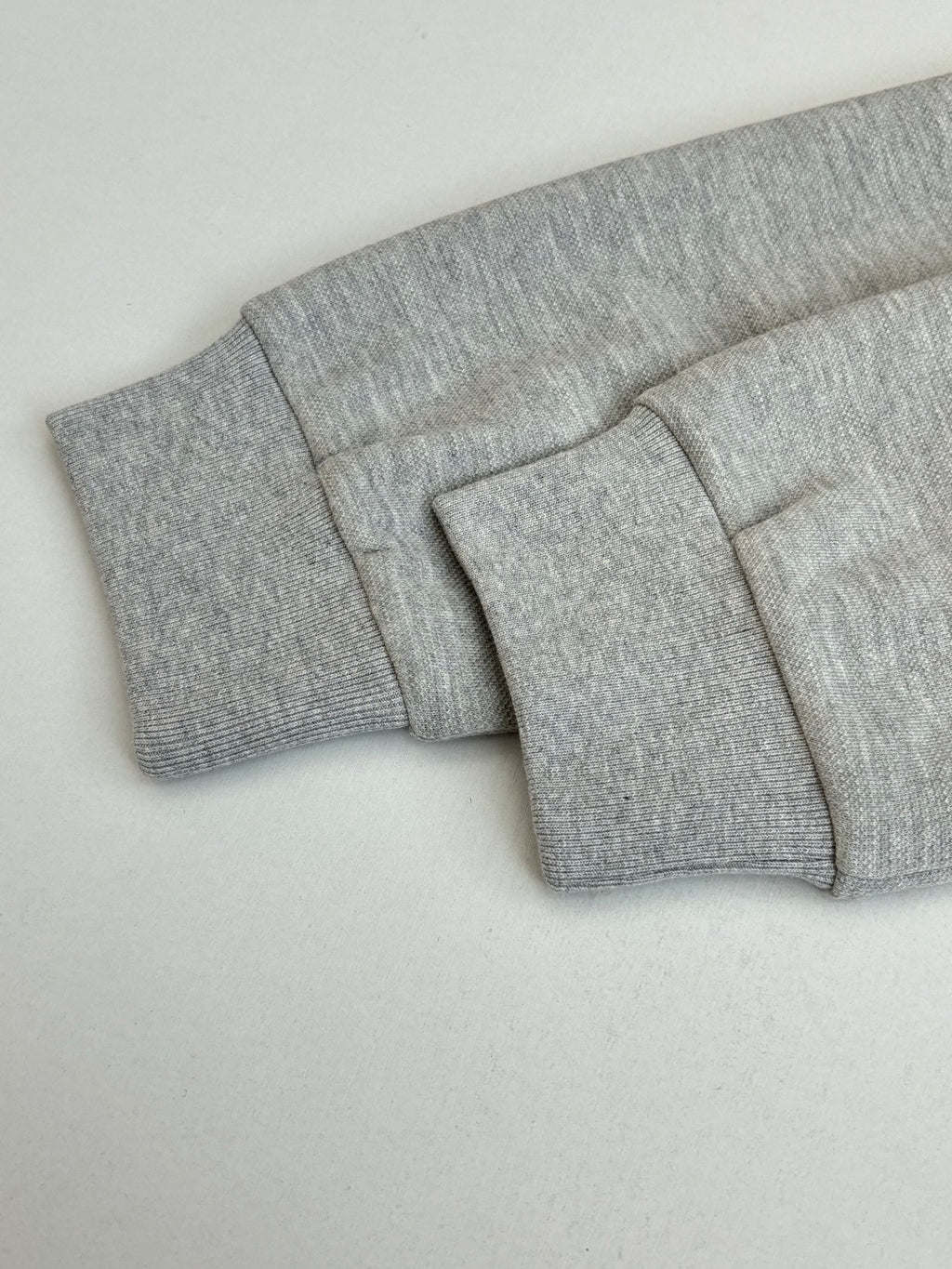 Grey pants waistband and folded cuff detail, clean flat front view