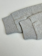 Grey pants waistband and folded cuff detail, clean flat front view