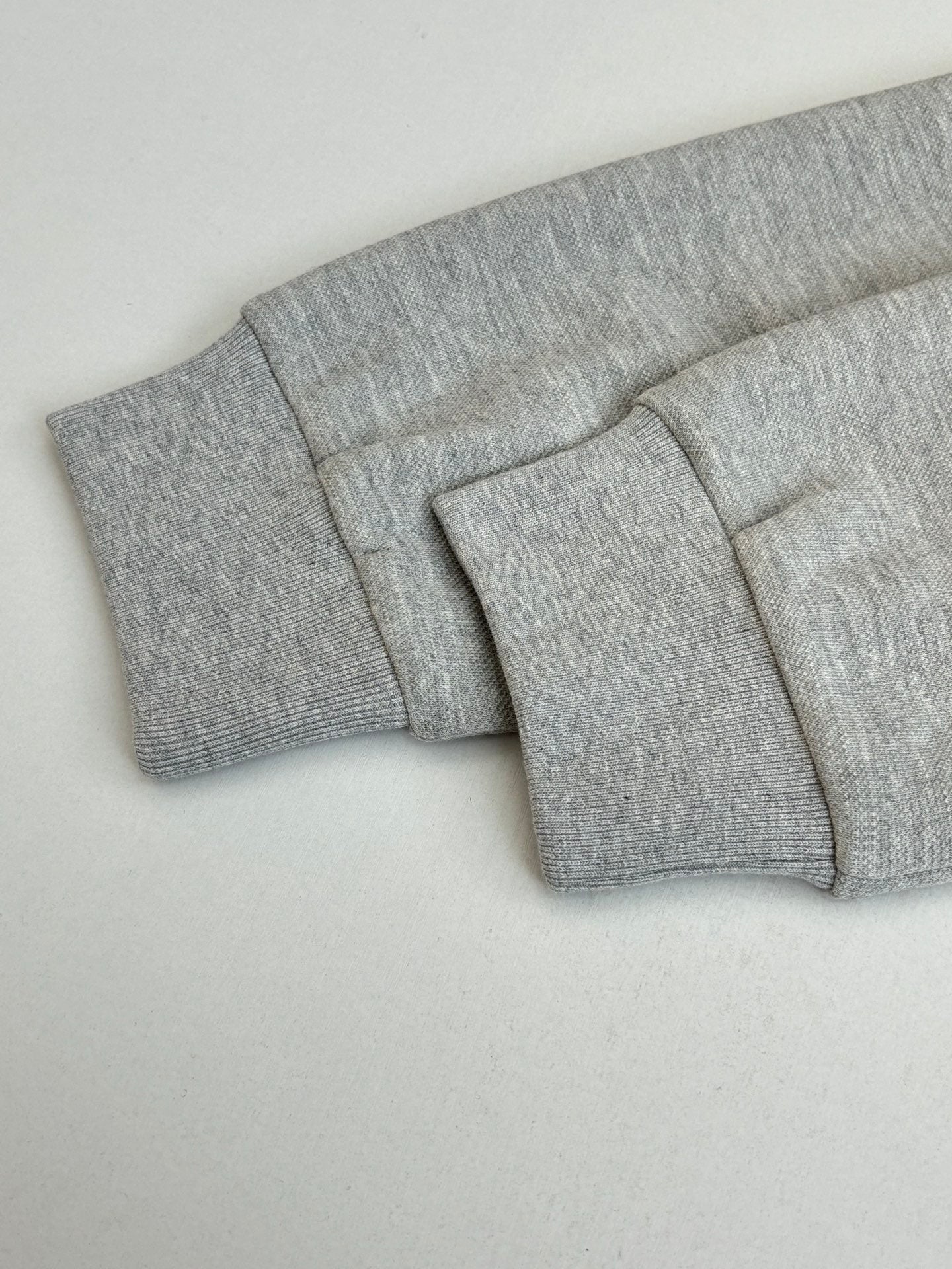 Grey pants waistband and folded cuff detail, clean flat front view