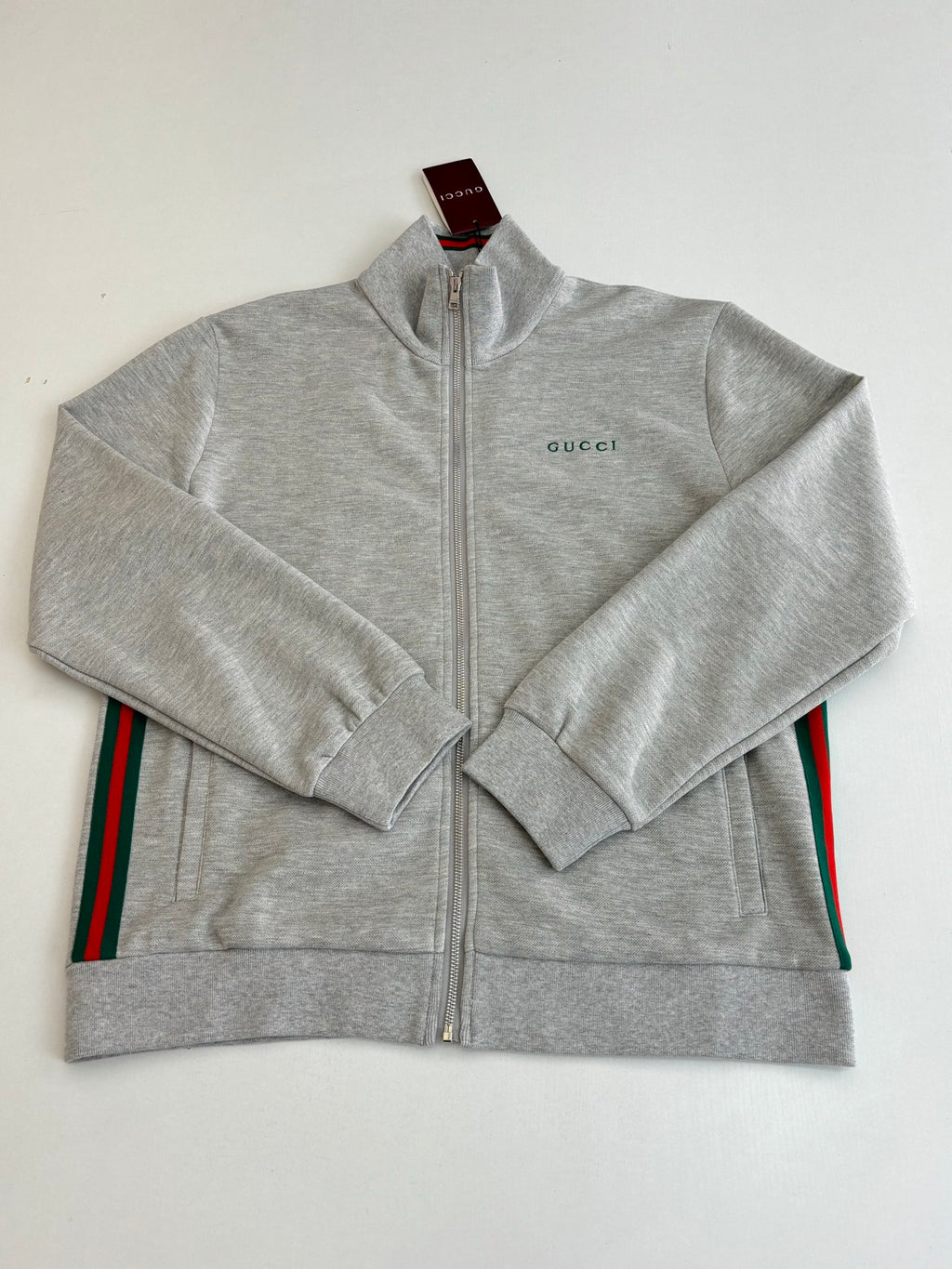 Grey Gucci zip-up jacket with side stripe details, front view