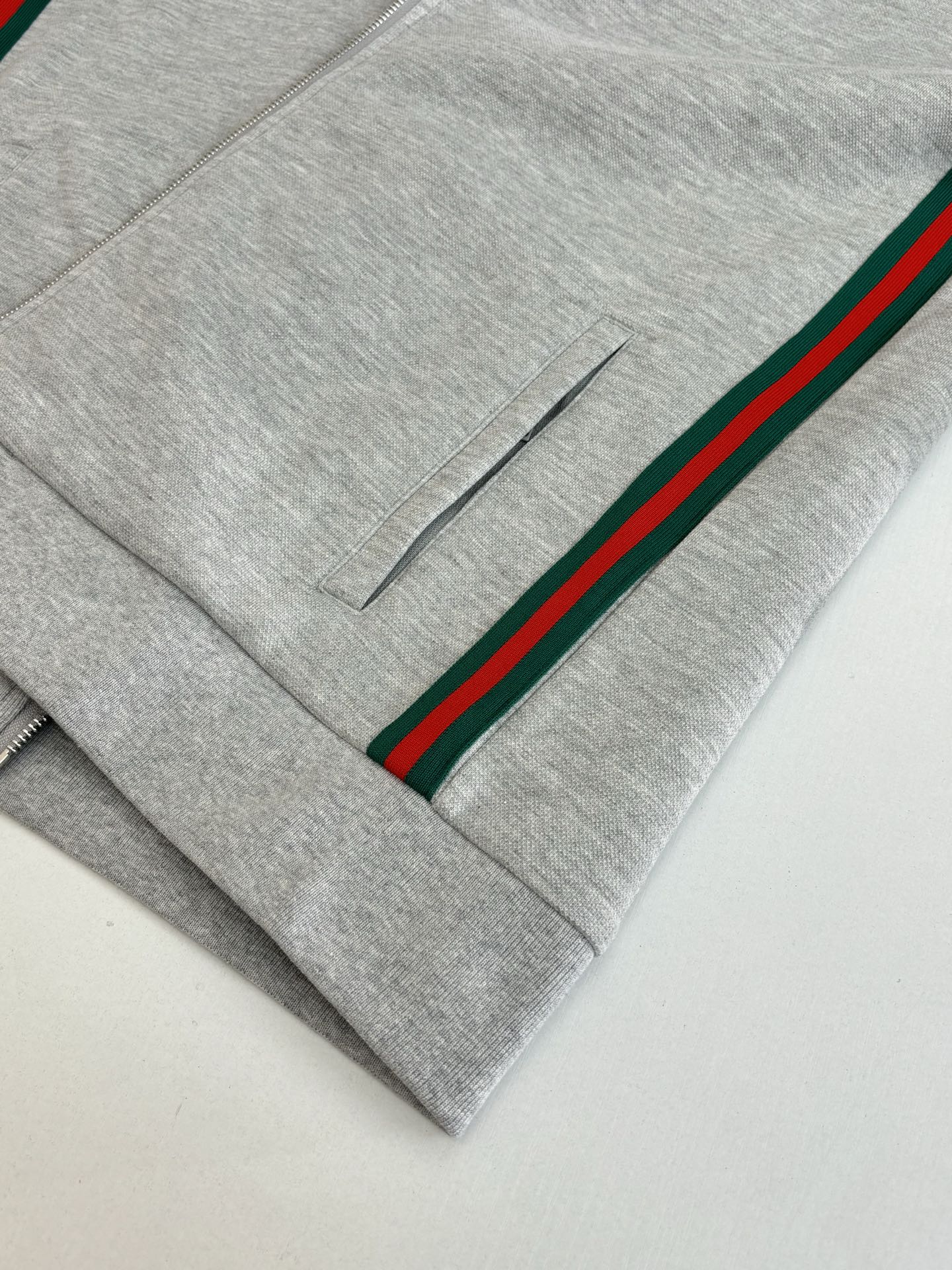 Grey pants front with green-red stripe side and small button placket