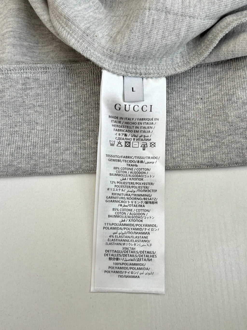 Gray top with Gucci size L care label