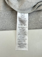 Gray top with Gucci size L care label