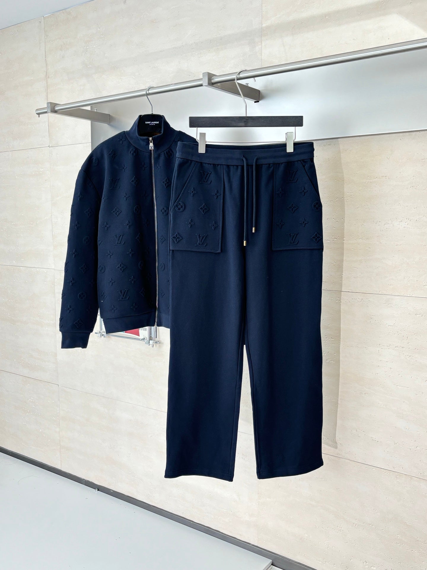 Dark navy monogram drawstring pants with elastic waistband and patch pockets