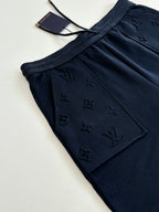 Dark navy pants with embossed monogram on front patch pocket