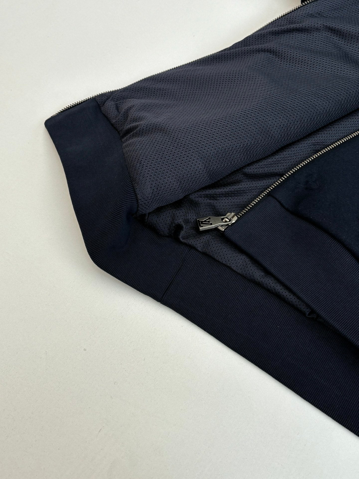 Louis Vuitton navy monogram track pants seam and pocket detail