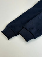 Louis Vuitton navy monogram track pants leg cuff close-up