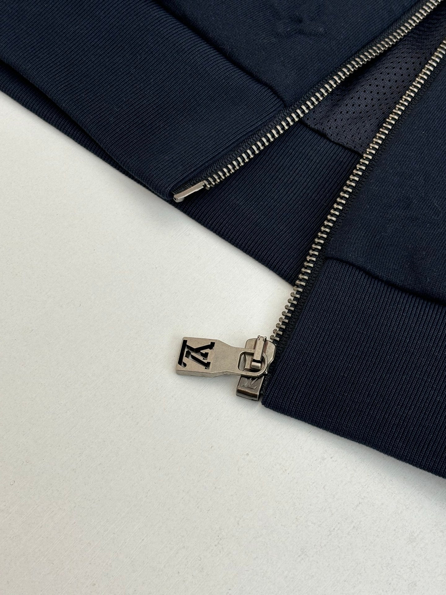 Louis Vuitton navy jacket zipper detail with metal pull