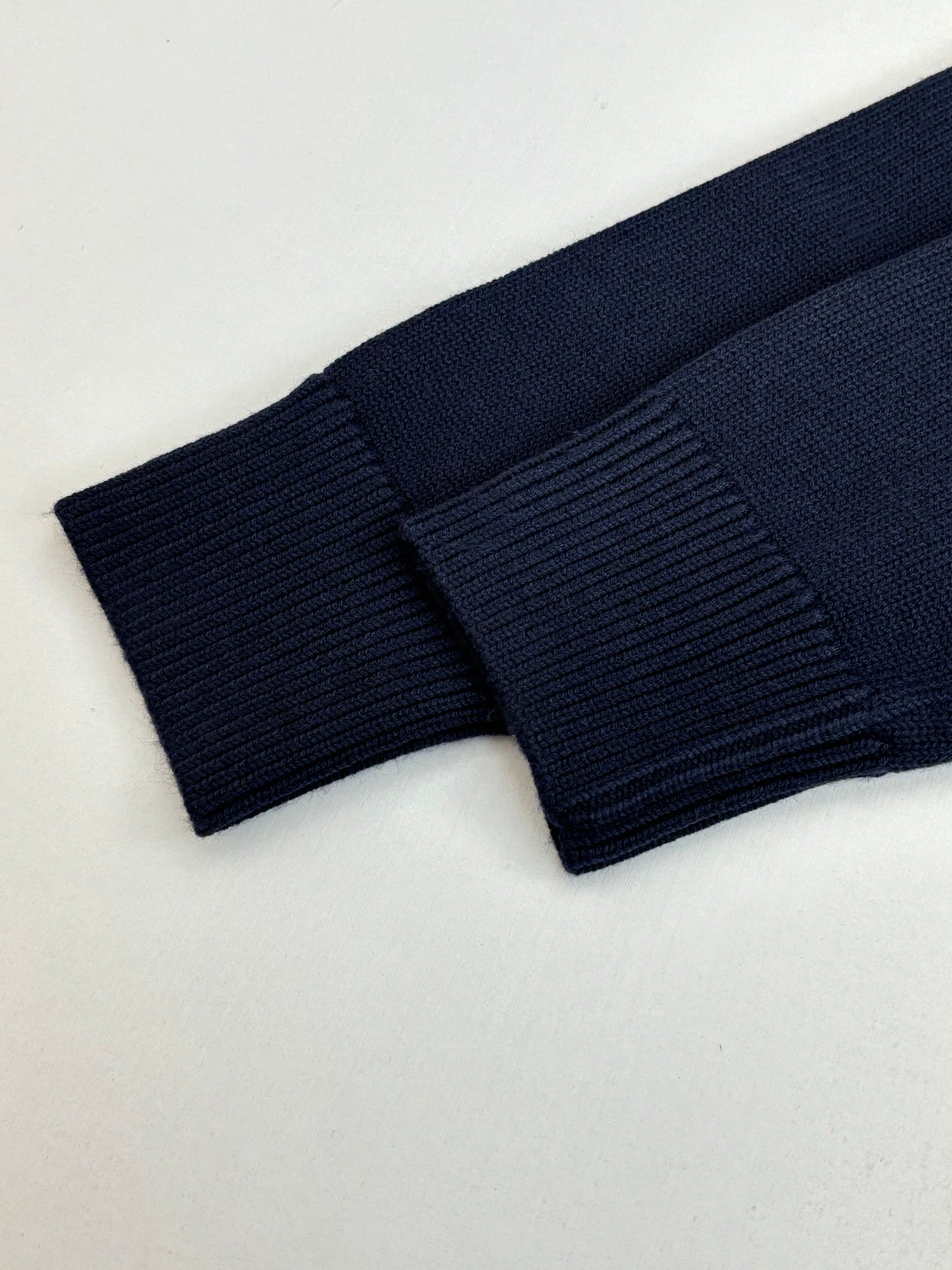 Navy knit sweater ribbed cuff and sleeve end detail