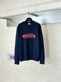 Navy long-sleeve knit sweater with red MONCLER logo across the chest