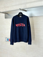 Navy long-sleeve knit sweater with red MONCLER logo across the chest
