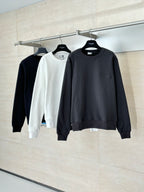 Hanging crewneck sweatshirts in dark and white