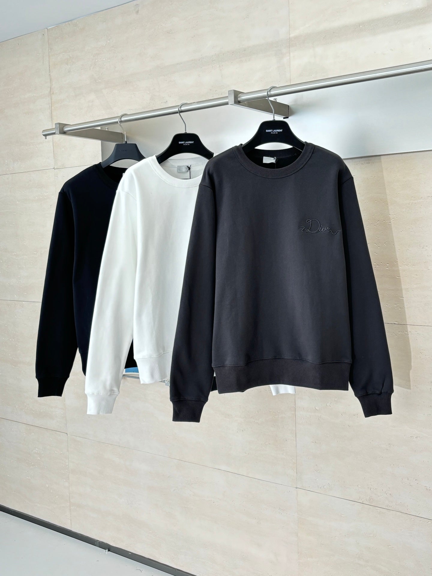 Hanging crewneck sweatshirts in dark and white