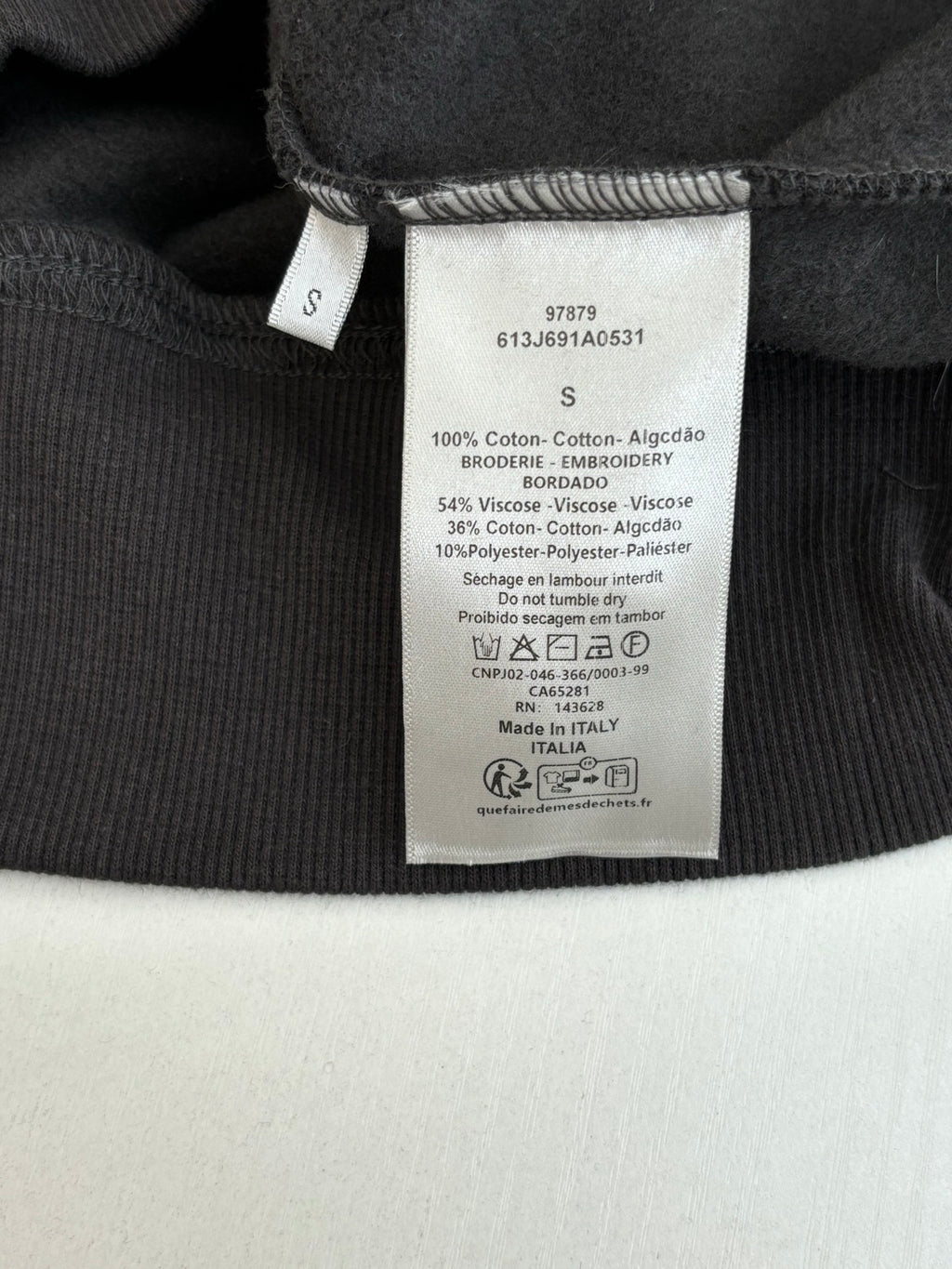 Dior long clothes with interior care label on dark fabric