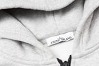 Heather gray hoodie interior label on hood lining with black drawcord ends
