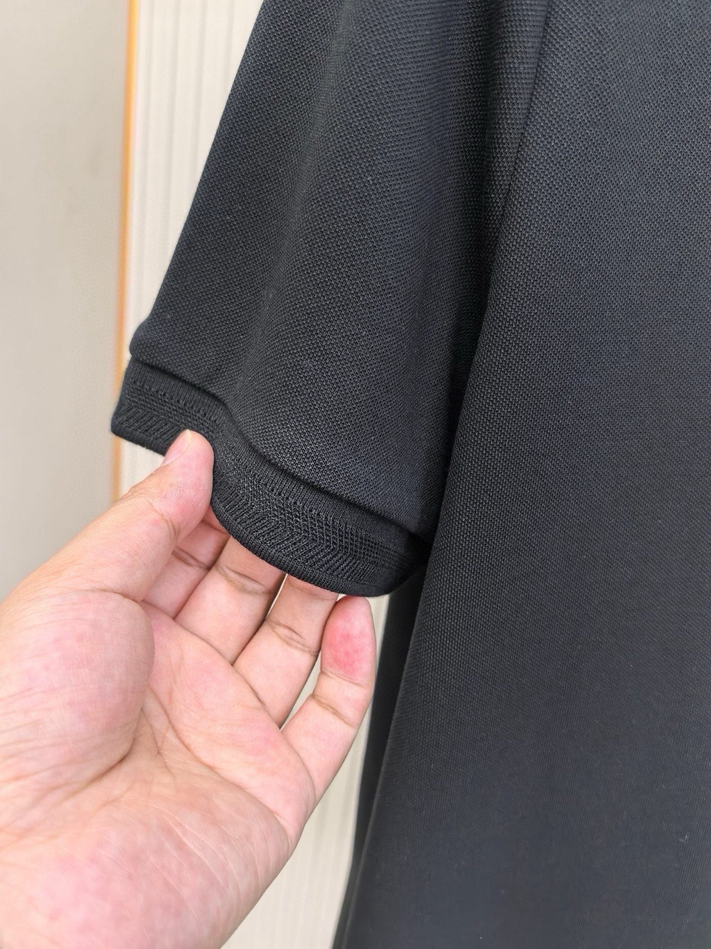 Burberry polo shirt sleeve cuff in dark navy knit fabric, with ribbed hem.