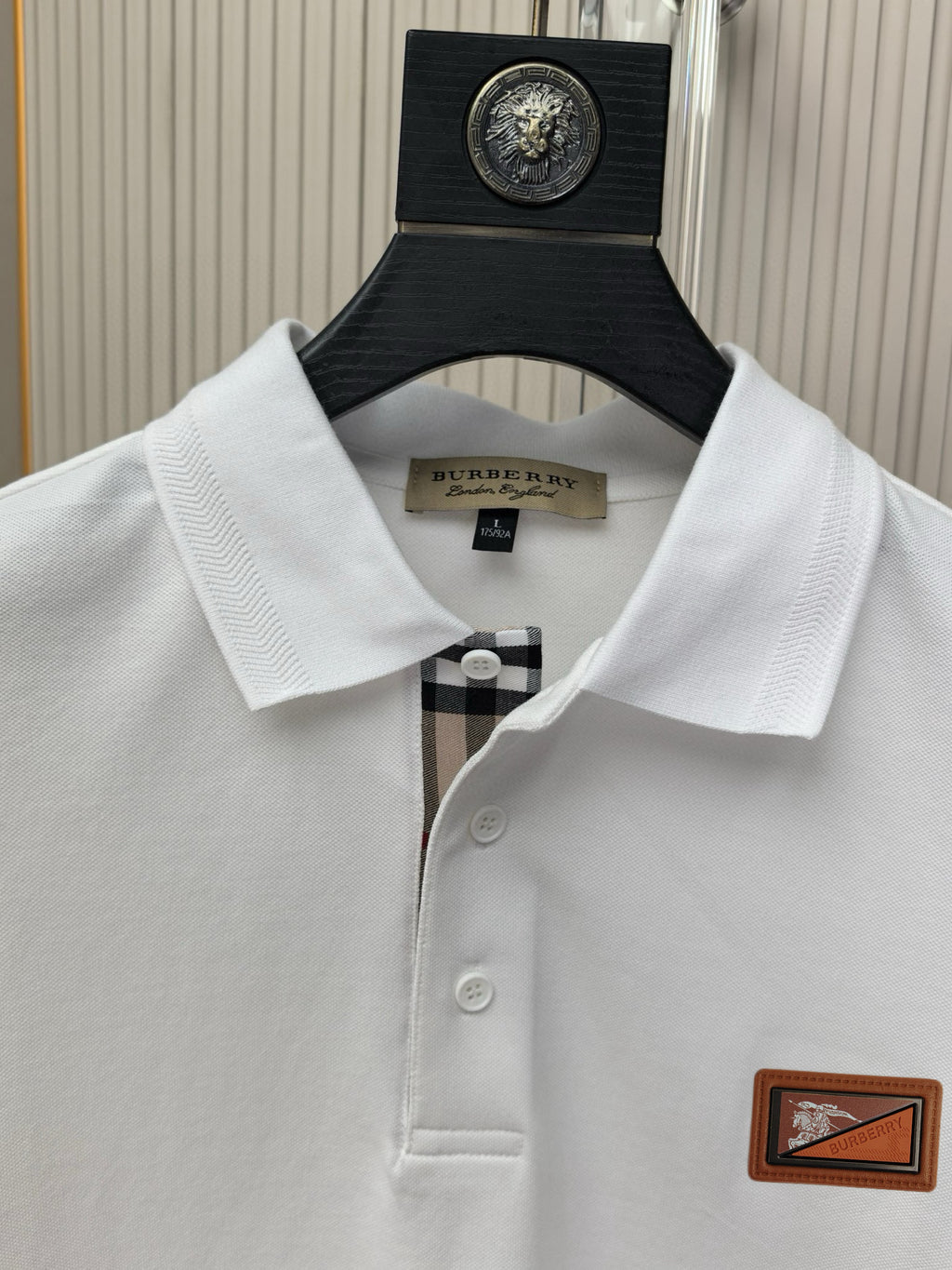 White polo shirt collar and buttons with Burberry logo patch