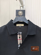 Burberry polo shirt collar close-up, dark navy with check inner placket and buttons
