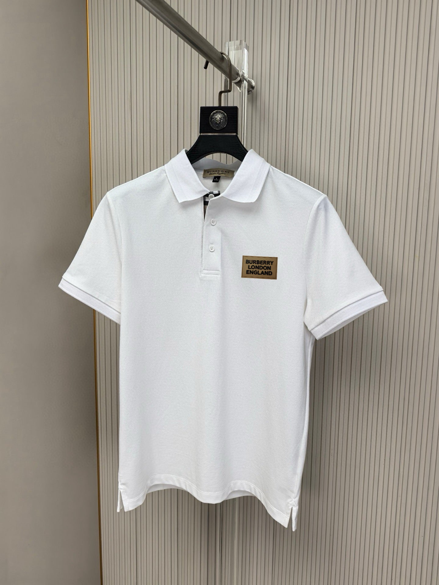 White polo shirt with point collar and button placket, small Burberry London England logo