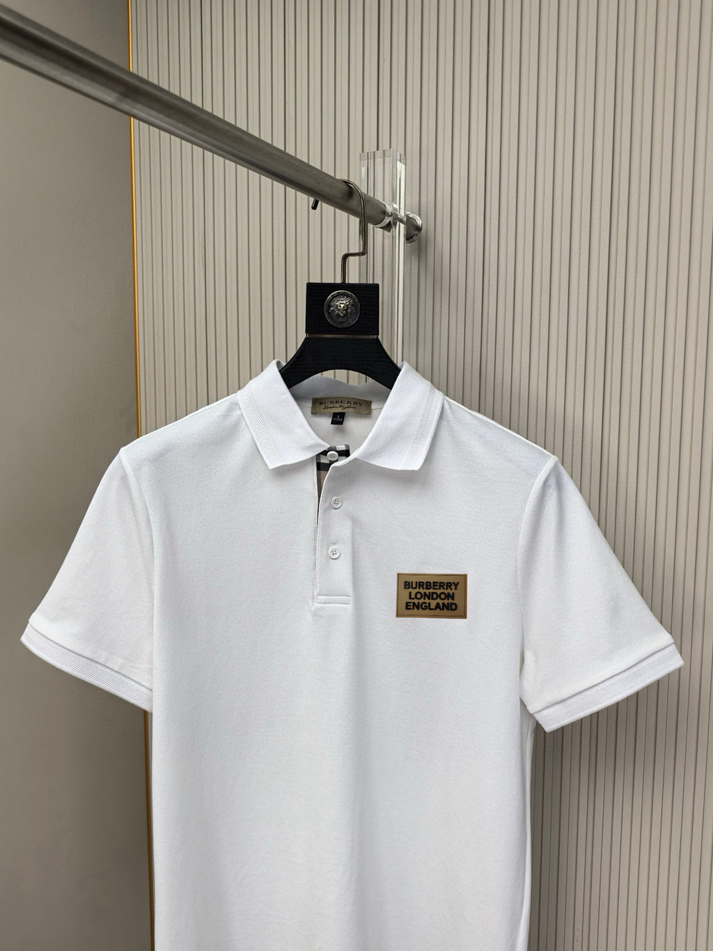 White polo shirt front view with button placket and Burberry London England logo