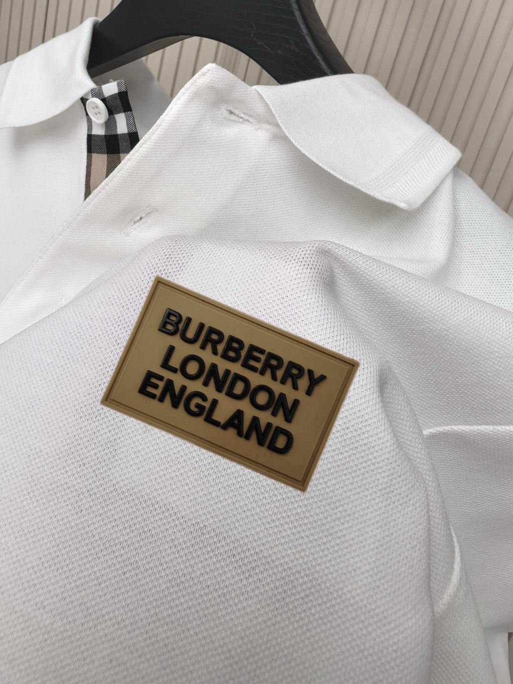 White polo shirt with textured fabric and Burberry London England logo patch