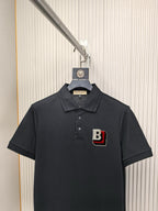 Burberry polo shirt with front button placket and B logo patch, dark black