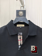 Burberry polo shirt close-up: dark black collar with check detail inside placket