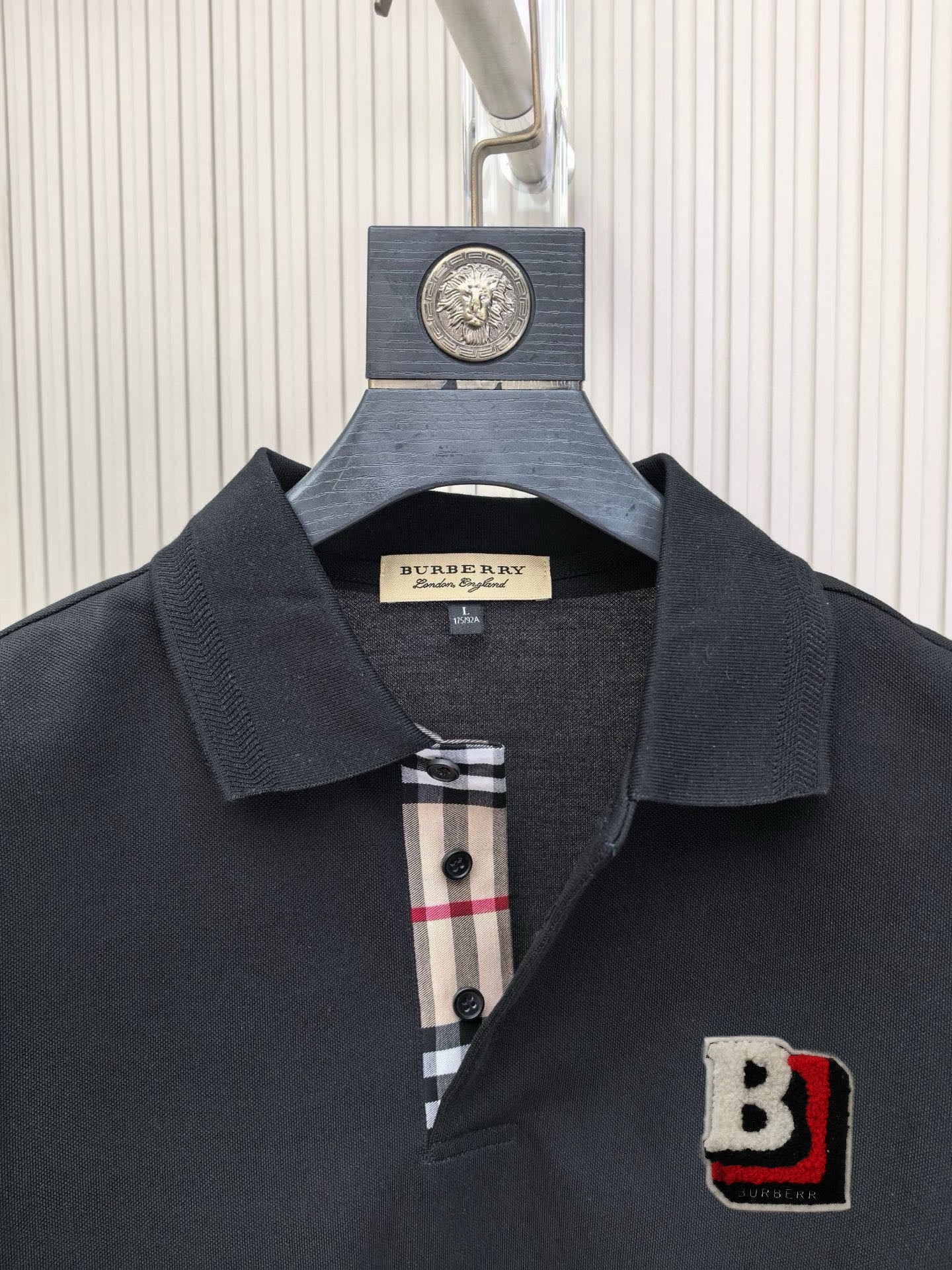 Burberry polo shirt close-up: dark black collar with check detail inside placket