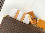 Louis Vuitton handbag with white monogram canvas, tan belt-like strap and top handle